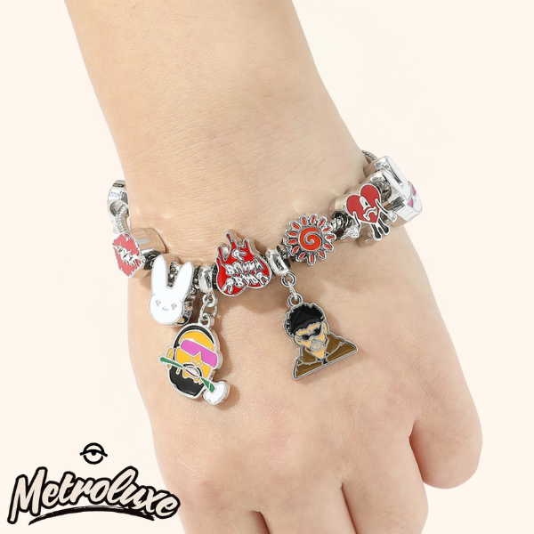 Bracelet with various charms on a wrist, featuring the brand 'MetroLuxe'.