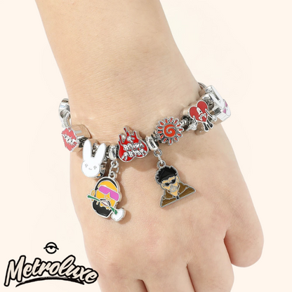Bracelet with various charms on a wrist, featuring the brand 'MetroLuxe'.