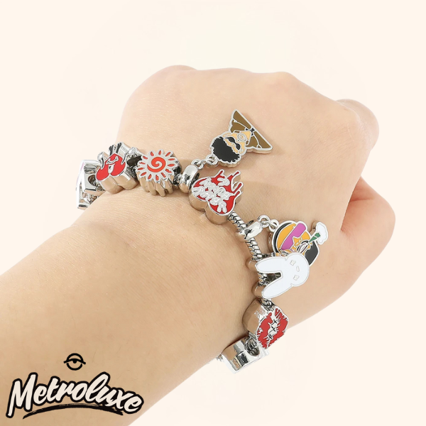Bracelet with various charms on a hand, branded 'Metroluxx'.